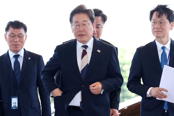 South Korean new President Lee Jae-myung, center, arrives at presidential office in Seoul after the inauguration Wednesday, June 4, 2025. (Chung Sung-Jun/Pool Photo via AP)