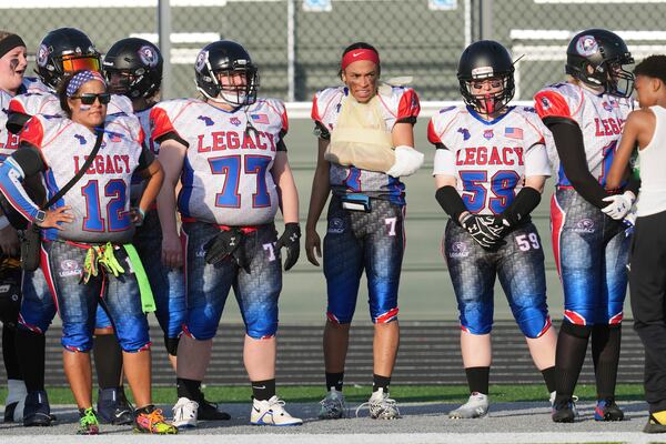 Lansing Legacy's Alexis Johnson stands on the sidelines with her arm wrapped after being injured in an AWFL women's football game against the Detroit Prowl, in Allen Park, Mich., Saturday, May 10, 2025. (AP Photo/Paul Sancya)