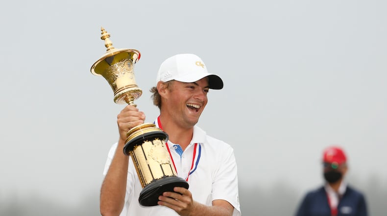 Georgia Tech's Tyler Strafaci holds aloft the Havemeyer Trophy for winning the U.S. Amateur championship at Bandon Dunes Golf Resort in Bandon, Ore., August 16, 2020.