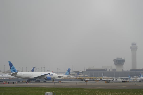Fog covers planes and control towers at Newark Liberty International Airport in Newark, N.J., Monday, May 5, 2025. (AP Photo/Seth Wenig)