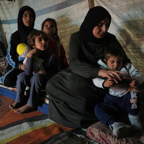 Rotana al-Regeb, who was allowed into Gaza from Egypt following the long-awaited reopening of the Rafah border crossing, reunites with her children in Khan Younis, southern Gaza Strip, Tuesday, Feb. 3, 2026. (AP Photo/Jehad Alshrafi)