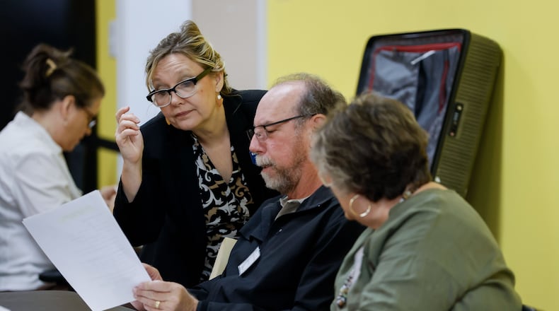 Spalding County Elections Supervisor Kim Slaughter helps poll workers during a hand count of ballots Thursday. The county’s majority-Republican election board voted 3-1 in August to require the hand count of this year’s elections and withhold certification of elections until any discrepancies are resolved. Miguel Martinez /miguel.martinezjimenez@ajc.com