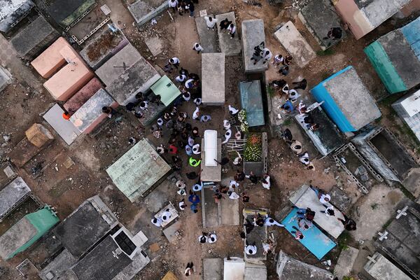 Family and friends attend the burial service for Marilenny Pilarte who died at the Jet Set nightclub when its roof collapsed, in Haina, Dominican Republic, Thursday, April 10, 2025. (AP Photo/Matias Delacroix)