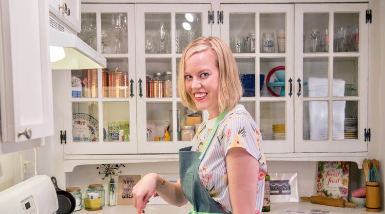 Mary Alice Cain is shown at work in her kitchen, where she developed the recipe book using food found at Dollar General. Courtesy of Kate Blohm Photography