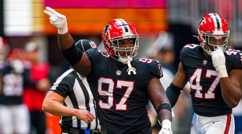 Atlanta Falcons defensive end Grady Jarrett (97) signals during the first half of an NFL football game against the San Francisco 49ers, Sunday, Oct. 16, 2022, in Atlanta. (AP Photo/Danny Karnik)