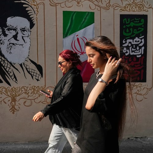 Women walk past a portrait of the late Iranian Supreme Leader Ayatollah Ali Khamenei, who was killed in the U.S. and Israel strike on Feb. 28, and images of the Iranian flag, on a sidewalk in downtown Tehran, Iran, Thursday, Aug. 20, 2026. (AP Photo/Vahid Salemi)