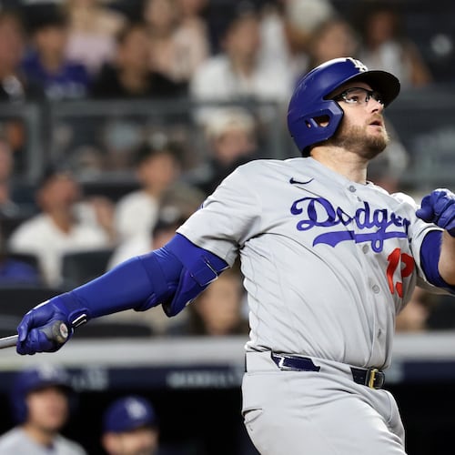 Los Angeles Dodgers' Max Muncy watches his two-run home run during the seventh inning of a baseball game against the New York Yankees, Friday, July 17, 2026, in New York. (AP Photo/Adam Hunger)