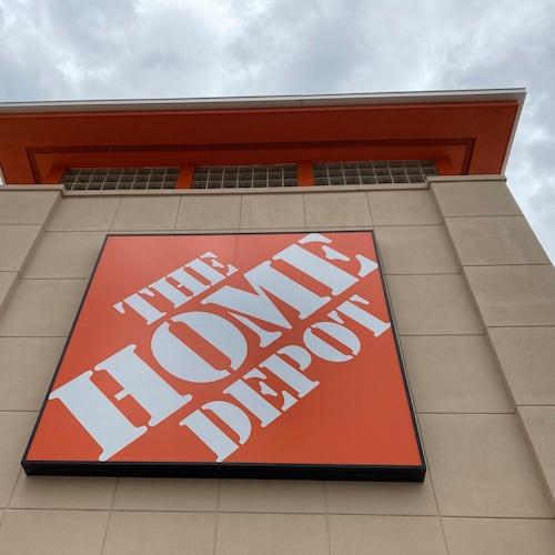 A Home Depot logo sign hands on its facade in North Miami, Fla. The Vinings-based company plans to acquire specialty building products distributor GMS Inc. (AP FILE 2021)