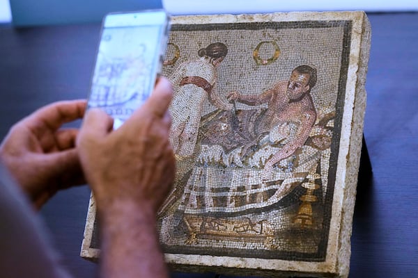 A Roman mosaic depicting a pair of lovers, which was repatriated from Germany, is displayed to journalists in the auditorium of Pompeii archaeological park, Tuesday, July 15, 2025. (AP Photo/Gregorio Borgia)