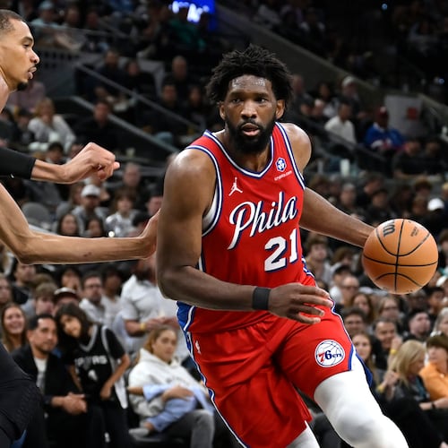 Philadelphia 76ers center Joel Embiid (21) drives against San Antonio Spurs center Victor Wembanyama, left, during the first half of an NBA basketball game, Monday, April 6, 2026, in San Antonio. (AP Photo/Darren Abate)