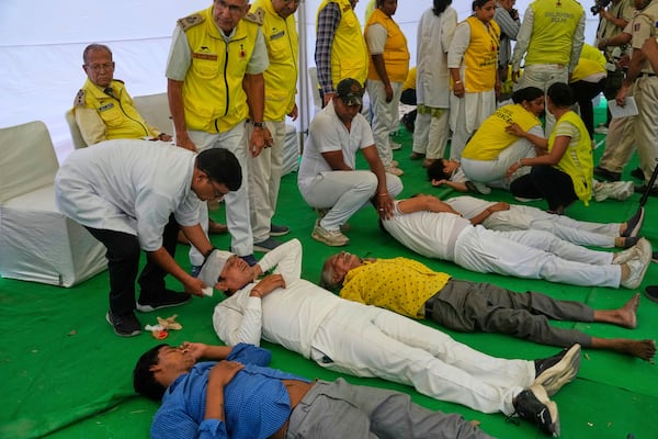Civil defense members carry out a mock drill in a market to train civilians and security personnel to respond in case of attack, in New Delhi, India, Wednesday, May 7, 2025. (AP Photo/Manish Swarup)