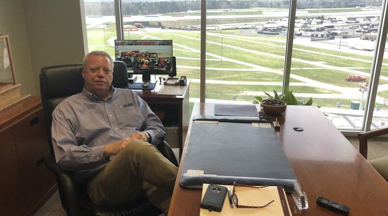 Atlanta Motor Speedway President Ed Clark sits above a quiet track Friday, soon after the Folds of Honor QuikTrip 500 was postponed because of the coronavirus outbreak. (Steve Hummer/AJC Photo)