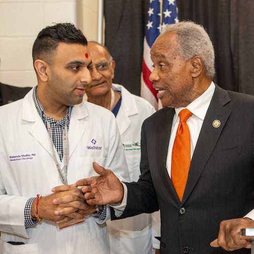 Rep. David Scott hosted his annual health fair on Saturday, Aug 16, 2025 where he met Wellstar Dr. Rakendu Shukla at Rockdale County High School in Conyers. (Jenni Girtman for the AJC)