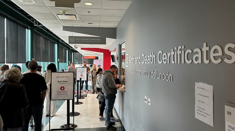 Customers stand in line to get birth and death certificates at the Columbus Public Health Department in Columbus, Ohio, on Tuesday, March, 10, 2026. (AP Photo/Julie Carr Smyth)