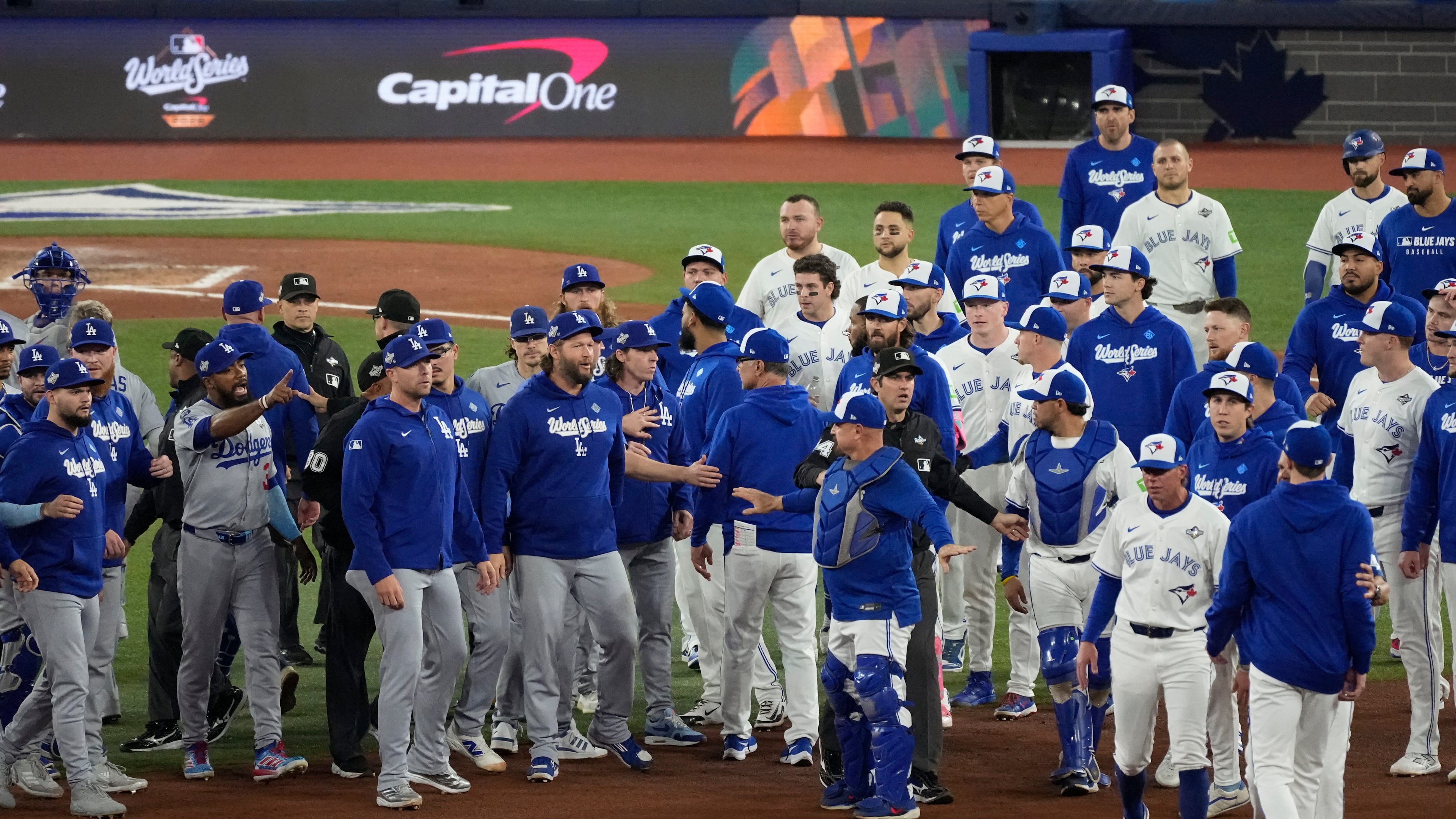 The Los Angeles Dodgers and the Toronto Blue Jays benches clear after Blue Jays' Andrés Giménez was hit by a pitch during the fourth inning in Game 7 of baseball's World Series, Saturday, Nov. 1, 2025, in Toronto. (AP Photo/Ashley Landis)