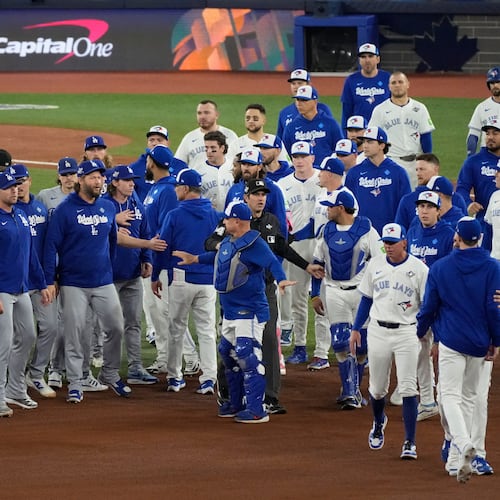 The Los Angeles Dodgers and the Toronto Blue Jays benches clear after Blue Jays' Andrés Giménez was hit by a pitch during the fourth inning in Game 7 of baseball's World Series, Saturday, Nov. 1, 2025, in Toronto. (AP Photo/Ashley Landis)