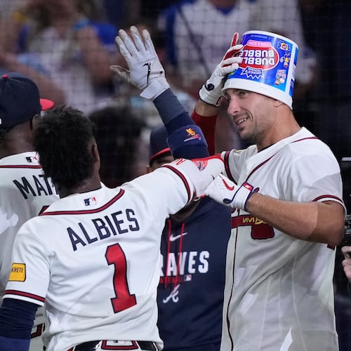 Bucket-headed first baseman Matt Olson celebrates his Wednesday walk-off. (Brynn Anderson/AP)