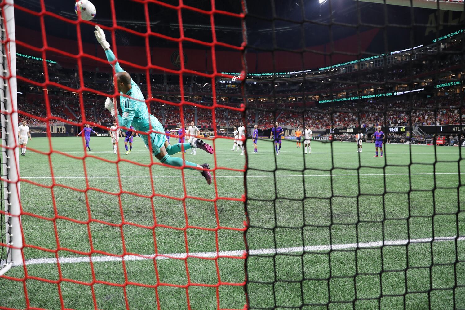 With an impressive catch, Columbus Crew goalkeeper Eloy Room (1) deflects a shot from Marcelino Moreno during the second half of an MLS soccer match at Mercedes-Benz Stadium on Saturday, May 28, 2022. Miguel Martinez / miguel.martinezjimenez@ajc.com