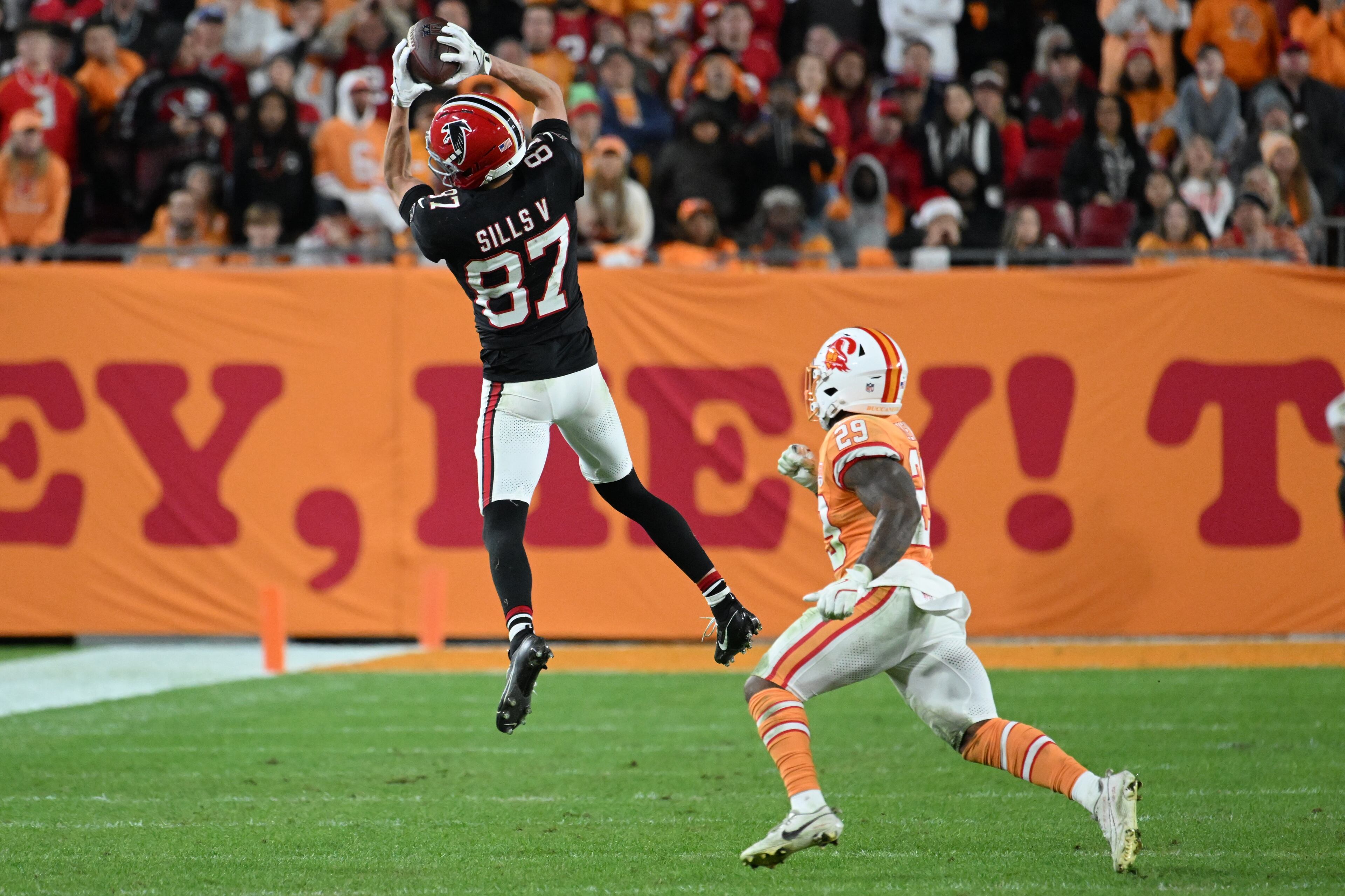 Atlanta Falcons wide receiver David Sills V (87) makes the catch against Tampa Bay Buccaneers safety Christian Izien (29) during the second half of an NFL football game, Thursday, Dec. 11, 2025, in Tampa, Fla. (AP Photo/Jason Behnken)