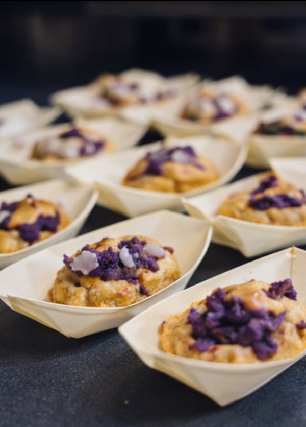 Paper boats hold chaat puri, garnished with diced ube.