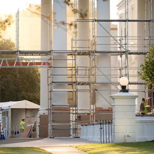 Workers remove scaffolding from columns at the North Portico of the White House, Tuesday, Sept. 8, 2026, in Washington. (AP Photo/Mark Schiefelbein)