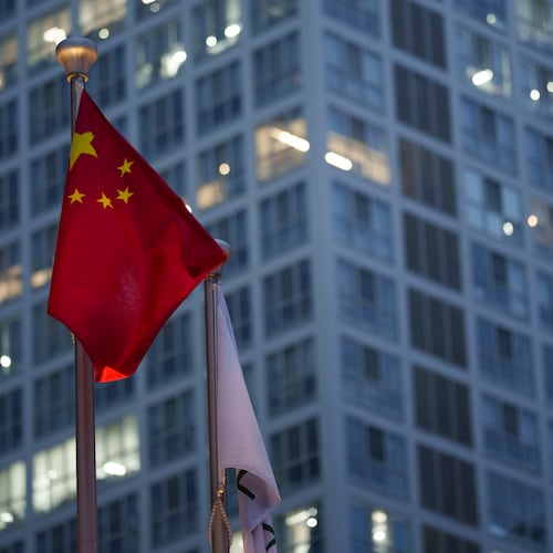Chinese flag is on display during a ate evening with the background of central business district in Beijing, China, Monday, July 15, 2024. (AP Photo/Vincent Thian)
