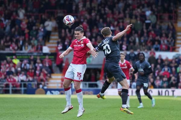 Wrexham's George Dobson, left, duels for the ball with Charlton Athletic's Greg Docherty during the English League One soccer match between Wrexham and Charlton Athletic at the Racecourse ground in Wrexham, Wales, Saturday, April 26, 2025. (AP Photo/Jon Super)
