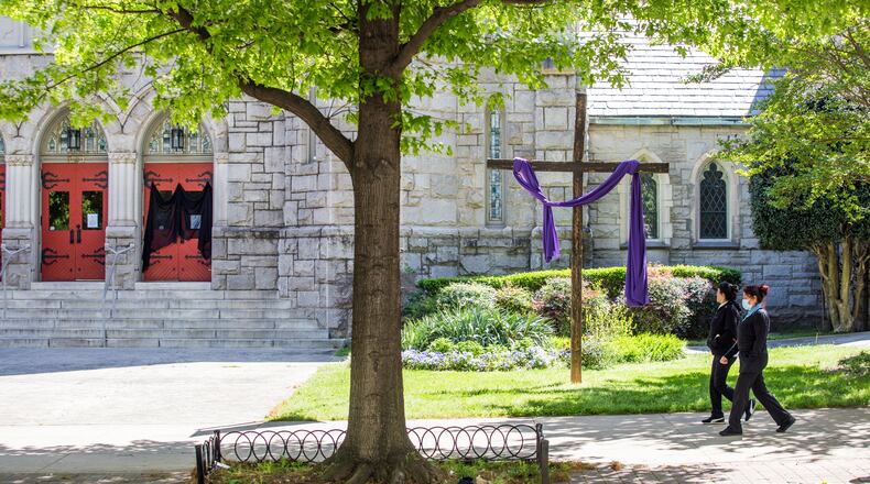 Saint Mark United Methodist Church on Peachtree Street has veiled one front door in observance of Good Friday on April 10, 2020. The veil also covers one of the posted messages that the church is closed until further notice. (Jenni Girtman for The Atlanta Journal-Constitution)
