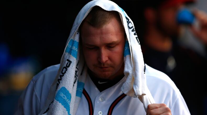 Trevor Cahill reacts in the dugout after being pulled in the third inning against the Marlins during his Braves debut at Turner Field on April 14, 2015 in Atlanta, Georgia. (Photo by Kevin C. Cox/Getty Images)