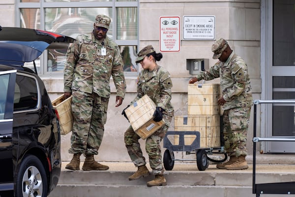 Troops load boxes of rifle ammunition at the District of Columbia National Guard Headquarters on Tuesday, Aug. 12, 2025 — a day after President Donald Trump ordered the National Guard to Washington, D.C., to expel homeless people and rid the capital of violent crime. (J. Scott Applewhite/AP)