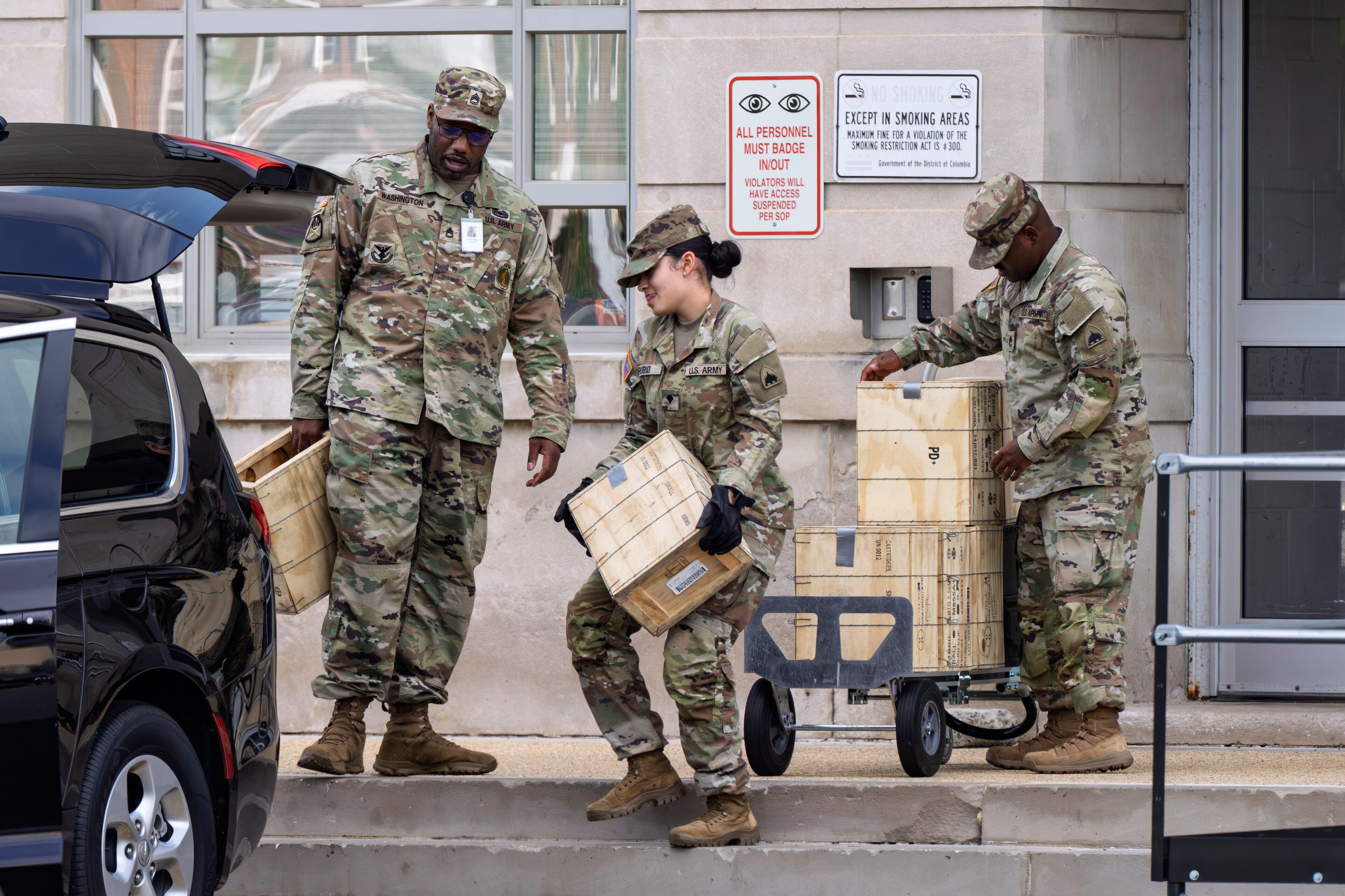 Troops load boxes of rifle ammunition at the District of Columbia National Guard Headquarters on Tuesday, Aug. 12, 2025 — a day after President Donald Trump ordered the National Guard to Washington, D.C., to expel homeless people and rid the capital of violent crime. (J. Scott Applewhite/AP)