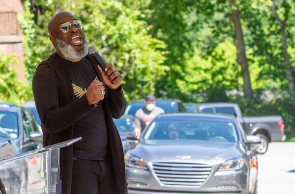 New Beginning Full Gospel Baptist Church Worship Leader Demetrius Banks talks to the church members in there cars during the drive-in Sunday service on May 3, 2020. STEVE SCHAEFER / SPECIAL TO THE AJC