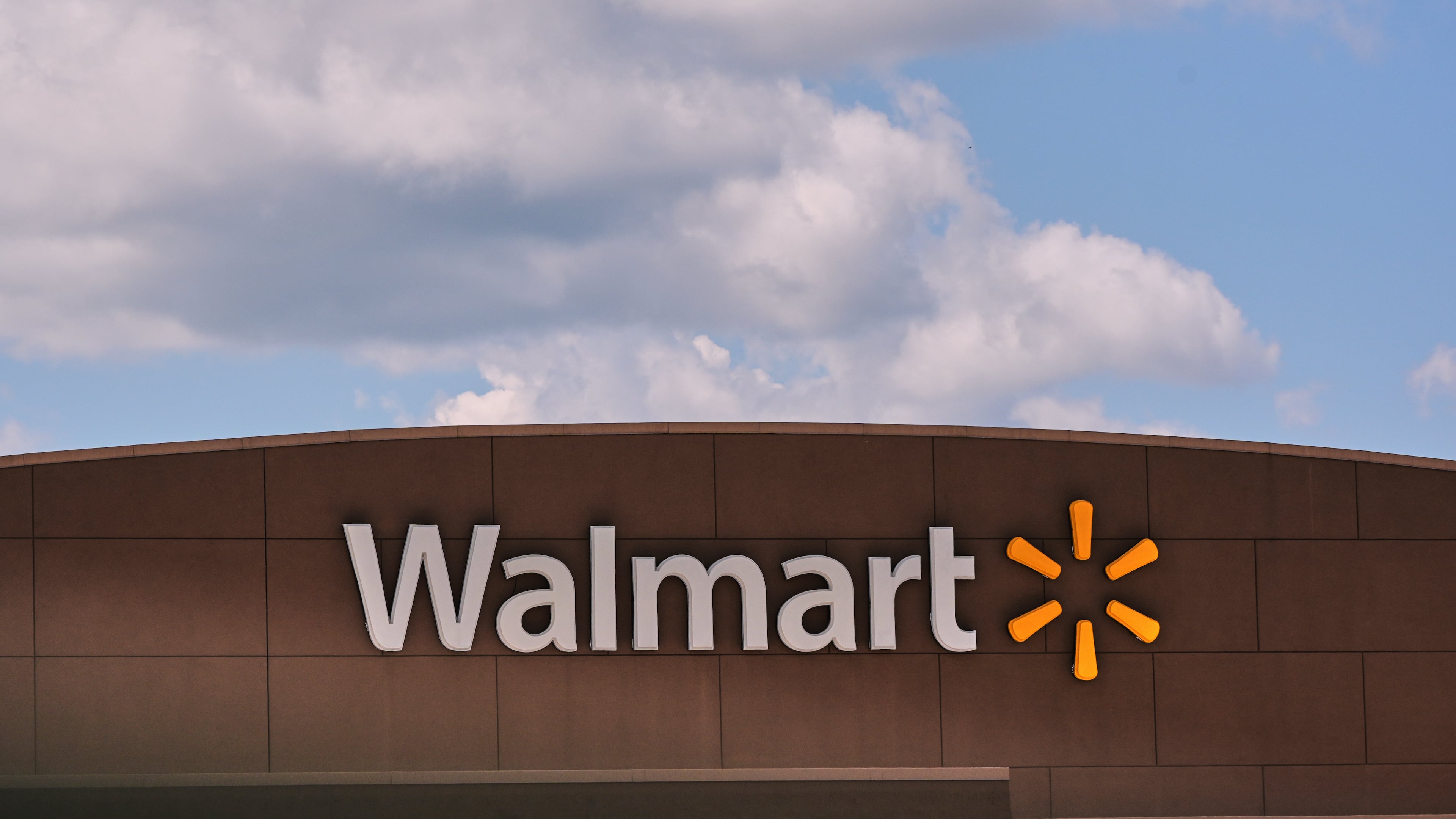 FILE - Clouds pass over the Walmart store, Thursday, Aug. 14, 2025, in Manchester, N.H. (AP Photo/Charles Krupa, File)