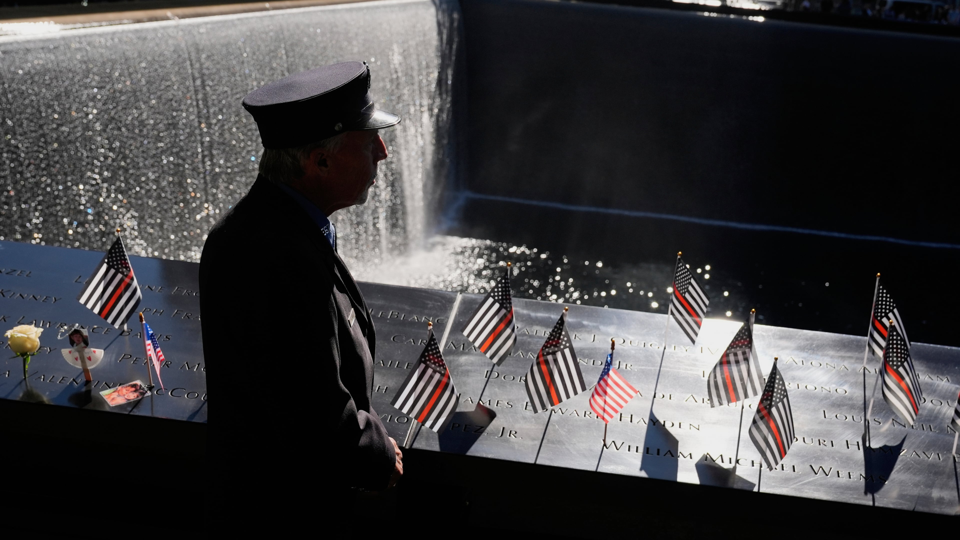 William Staudt, a firefighter that worked at Ground Zero on the day of the attacks, looks over a reflecting pool during a ceremony to mark the 24th anniversary of the 9/11 attacks, Thursday, Sept. 11, 2025, in New York. (AP Photo/Seth Wenig)