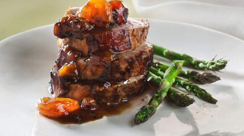 Pork tenderloin with apricot and prune sauce needs a wine to bring the zesty and sweet elements together. (Bill Hogan/Chicago Tribune/TNS)