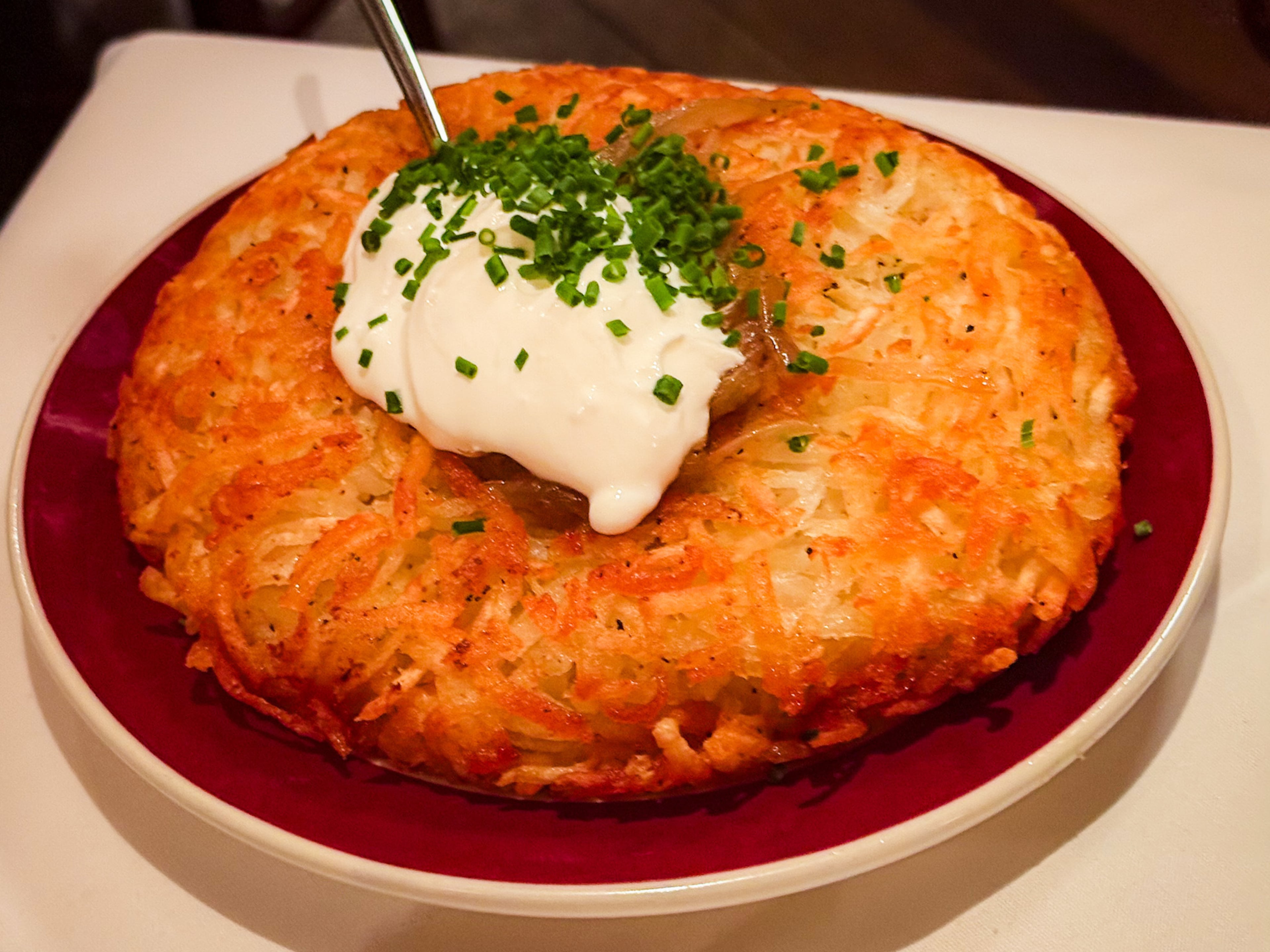 Bones isn’t stodgy or uncomfortably formal. A server might pat their own belly to explain just how much they enjoy the charged hash brown casserole you’re contemplating as an order. (Henri Hollis/AJC)