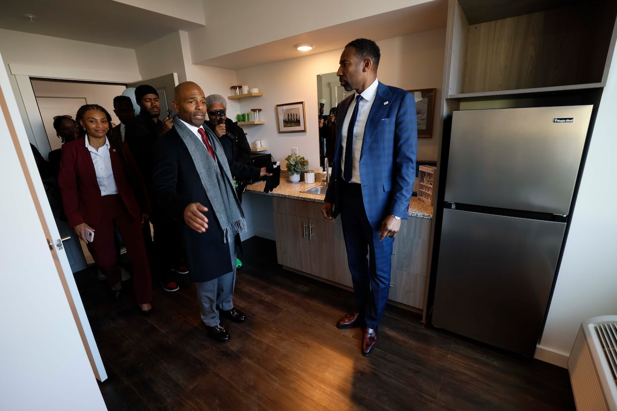 Managing Partner at Atlantica Properties, Darion Dunn (center) talks with Atlanta Mayor Andre Dickens during a tour following the ribbon cutting of Waterworks Village as part of the third phase of the city’s Rapid Housing Initiative on Wednesday, Dec. 3, 2025.
(Miguel Martinez/AJC)