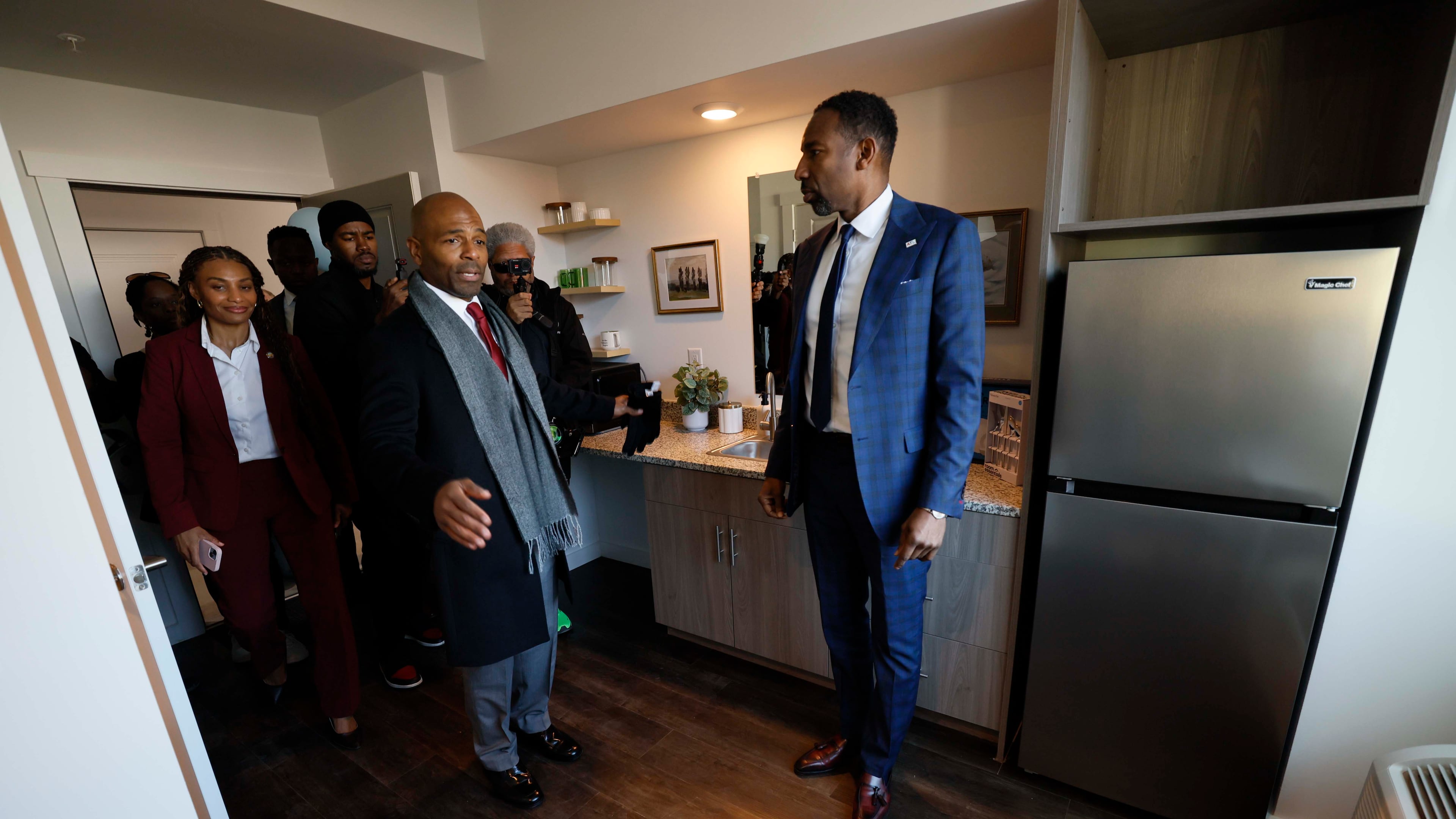 Managing Partner at Atlantica Properties, Darion Dunn (center) talks with Atlanta Mayor Andre Dickens during a tour following the ribbon cutting of Waterworks Village as part of the third phase of the city’s Rapid Housing Initiative on Wednesday, Dec. 3, 2025.
(Miguel Martinez/AJC)