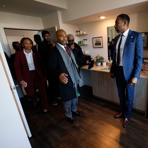 Managing Partner at Atlantica Properties, Darion Dunn (center) talks with Atlanta Mayor Andre Dickens during a tour following the ribbon cutting of Waterworks Village as part of the third phase of the city’s Rapid Housing Initiative on Wednesday, Dec. 3, 2025.
(Miguel Martinez/AJC)