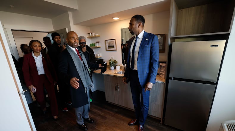 Managing Partner at Atlantica Properties, Darion Dunn (center) talks with Atlanta Mayor Andre Dickens during a tour following the ribbon cutting of Waterworks Village as part of the third phase of the city’s Rapid Housing Initiative on Wednesday, Dec. 3, 2025.
(Miguel Martinez/AJC)