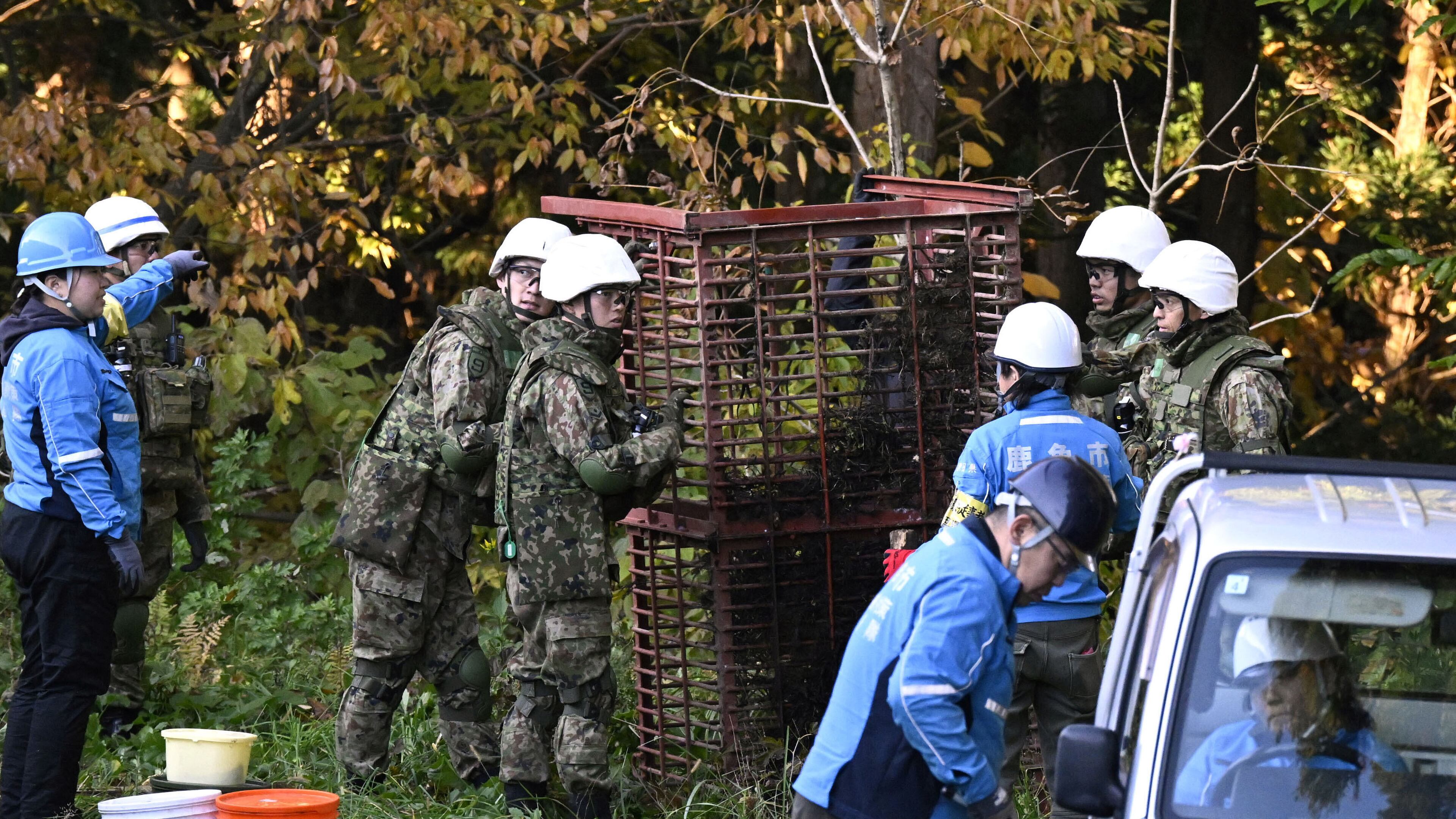 Japan Ground Self-Defense Force members and others set up a box trap to capture bears in Kazuno, Akita prefecture, northern Japan Wednesday, Nov. 5, 2025. (Muneyoshi Someya/Kyodo News via AP)