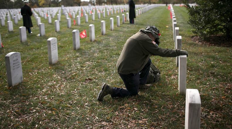 ARLINGTON, VA - Gulf War veteran John Schoon visits the gravesite of U.S.M.C. Sgt Christopher Hrbek one day before Veterans Day at Arlington National Cemetery on Friday, Nov. 10. Veterans Day, observed on November 11, honors all members of the U.S. military who served in the United States Armed Forces. WIN MCNAMEE/GETTY IMAGES
