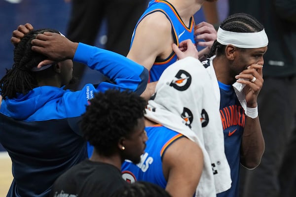 Oklahoma City Thunder guard Shai Gilgeous-Alexander, right, stands with teammates during a timeout during the second half of Game 6 of the NBA Finals basketball series against the Indiana Pacers, Thursday, June 19, 2025, in Indianapolis. (AP Photo/Michael Conroy)