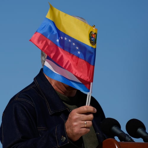 Cuban President Miguel Diaz-Canel waves Venezuelan and Cuban national flags during a rally in Havana, Saturday, Jan. 3, 2026, in solidarity after the U.S. captured President Nicolas Maduro and flew him out of Venezuela. (AP Photo/Ramon Espinosa)
