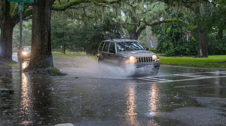 A car drives through a flooded street on Monday, August 5, 2024 in Savannah, GA. (AJC Photo/Katelyn Myrick)