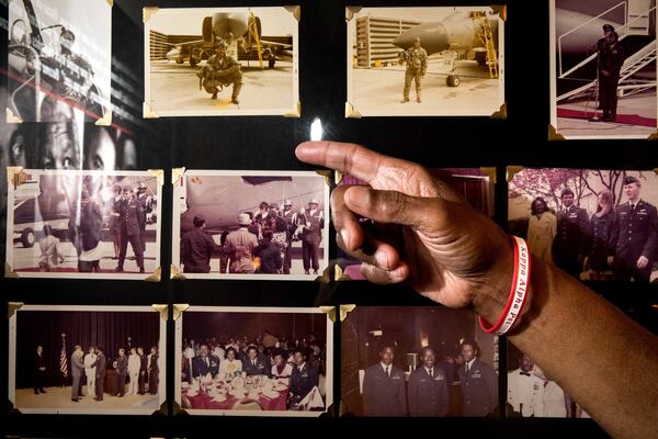 Former POW Lt. Col. James W. Williams, in Norcross this month, points to photos of himself taken during the Vietnam War. Willams was shot down while flying a F-4D Phantom during a mission over North Vietnam. BRANDEN CAMP/SPECIAL
