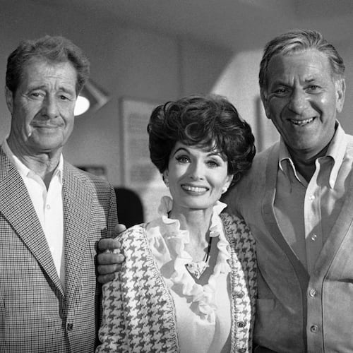 FILE - Don Ameche, left, and Ann Blyth, center, as guest stars, join Jack Klugman on the set for an episode of the television series, Quincy, June 22, 1978, Los Angeles, Calif. (AP Photo/Nick Ut, File)