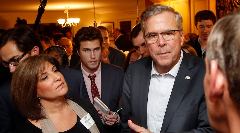 Former Florida Gov. Jeb Bush speaks with area residents at a packed house party Friday, March 13, 2015, in Dover, N.H. On his opening foray into New Hampshire for his likely campaign for the Republican presidential nomination, Bush challenged voters here to spend time learning about the issues and avoid shrill partisan sniping. (AP Photo/Jim Cole) Former Florida Gov. Jeb Bush in New Hampshire earlier this year. AP file/Jim Cole