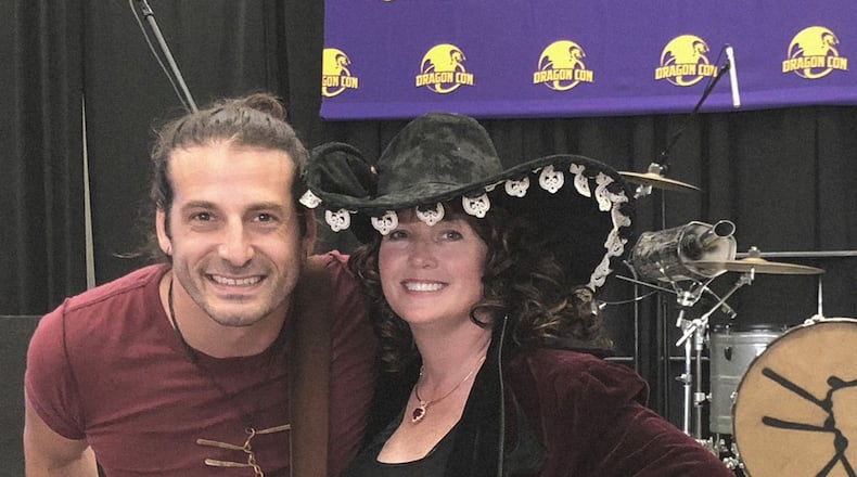 Sherrilyn Kenyon poses with a fan during last week’s Dragon Con festival, where she signed copies of “Stygian,” her latest book in the popular Dark-Hunter series. CONTRIBUTED