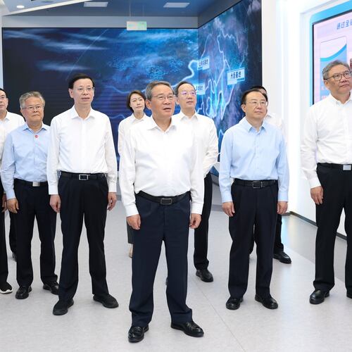 In this photo released by Xinhua News Agency, Chinese Premier Li Qiang, center, listens to enterprise introduction and report on the development of shipbuilding industry in Dalian at the Dalian Shipbuilding Industry Co., Ltd. in Dalian, northeastern China's Liaoning Province on Monday, June 22, 2026. (Huang Jingwen/Xinhua via AP)